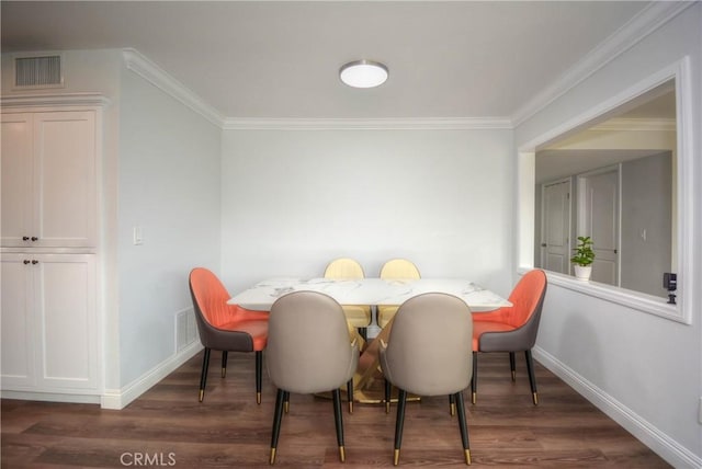 dining space featuring baseboards, visible vents, crown molding, and wood finished floors