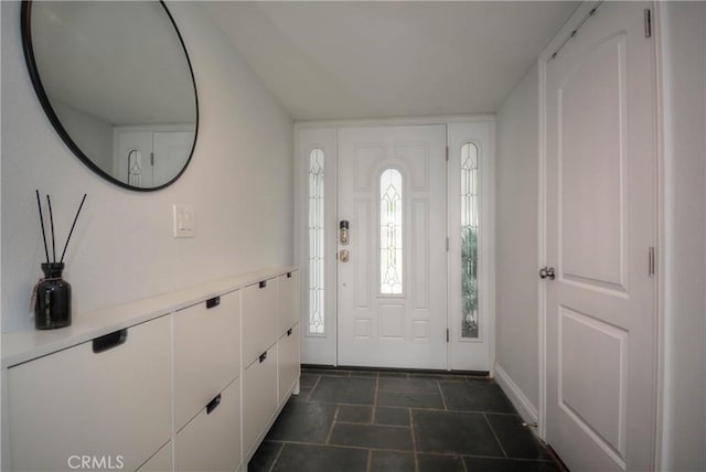 entrance foyer featuring stone finish floor