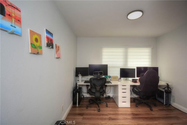 office area with baseboards and wood finished floors