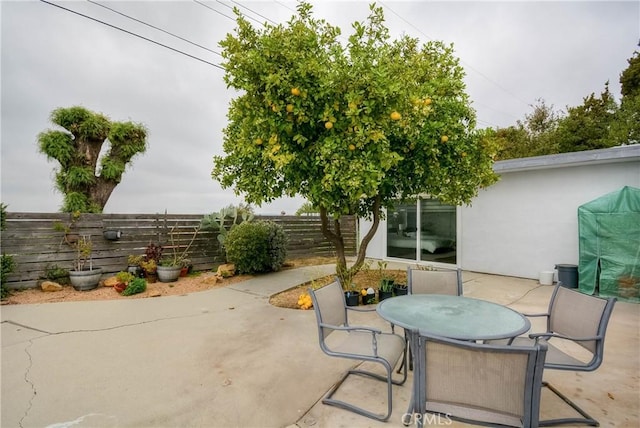 view of patio / terrace with outdoor dining area and fence
