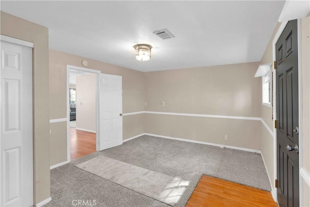 unfurnished room with visible vents, carpet flooring, and baseboards