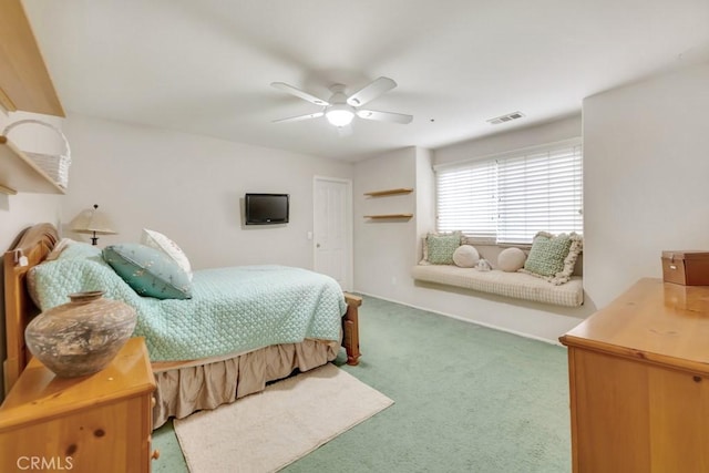 carpeted bedroom with visible vents and a ceiling fan