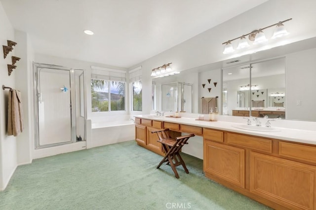 full bathroom with a shower stall, a garden tub, double vanity, and a sink