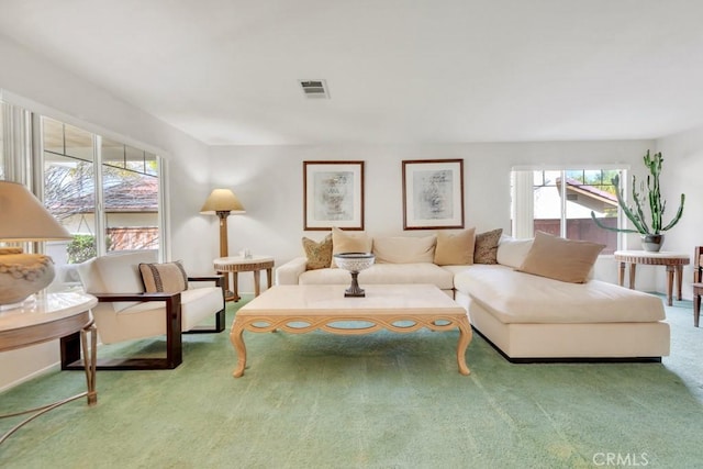 living area featuring visible vents and carpet floors