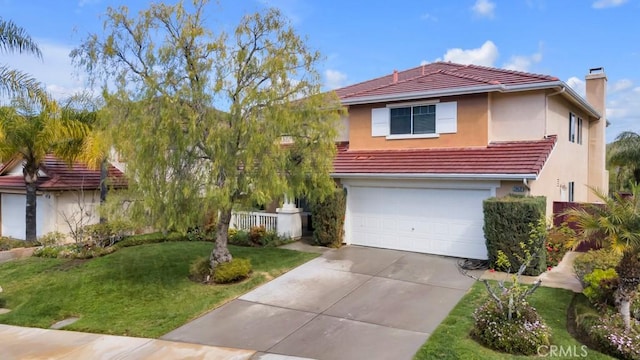 view of front of house featuring a garage, driveway, a tile roof, and a front lawn