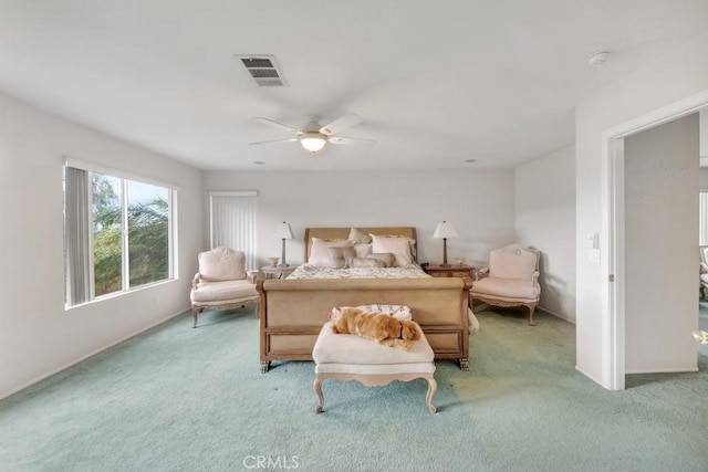 carpeted bedroom featuring visible vents and ceiling fan