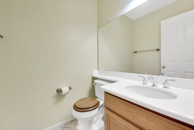 bathroom featuring tile patterned floors, toilet, vanity, and baseboards