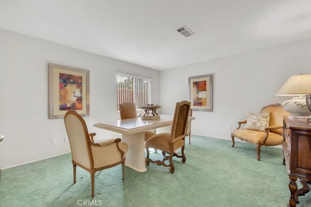 carpeted dining space featuring visible vents