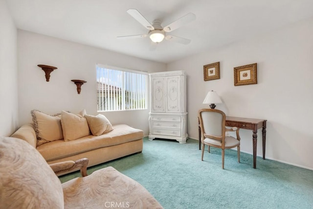 carpeted living room with a ceiling fan and baseboards