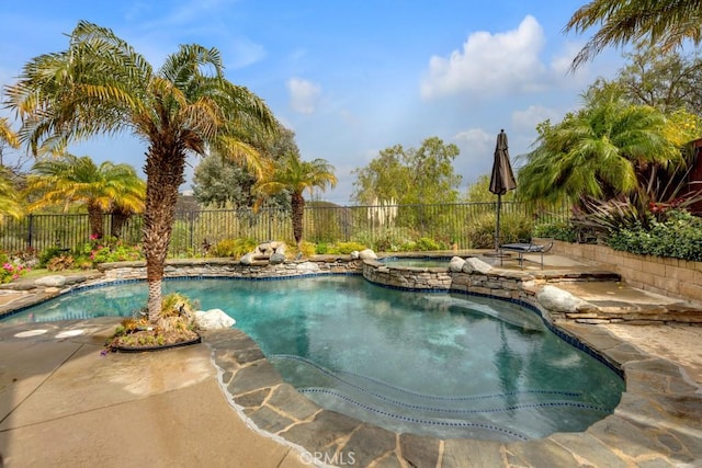 view of pool with a patio, a fenced backyard, a fenced in pool, and an in ground hot tub