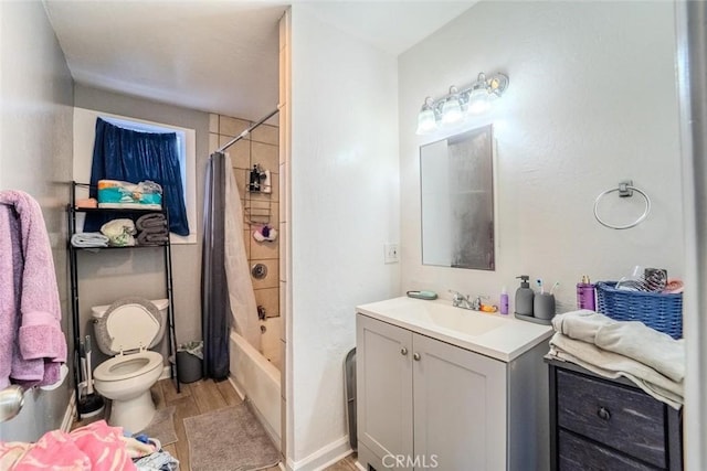 full bath featuring shower / bath combo with shower curtain, toilet, vanity, and wood finished floors