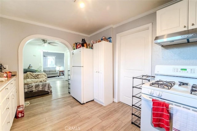 kitchen with white appliances, arched walkways, under cabinet range hood, white cabinetry, and light wood-type flooring