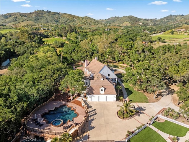 bird's eye view featuring a mountain view and a view of trees