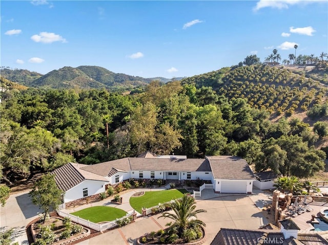 drone / aerial view with a forest view and a mountain view