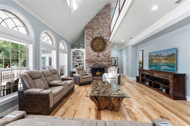 living area with a brick fireplace, baseboards, ornamental molding, hardwood / wood-style flooring, and high vaulted ceiling