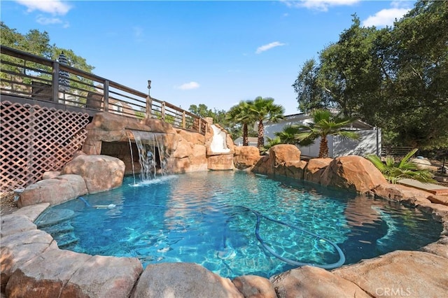 outdoor pool with fence and a water slide