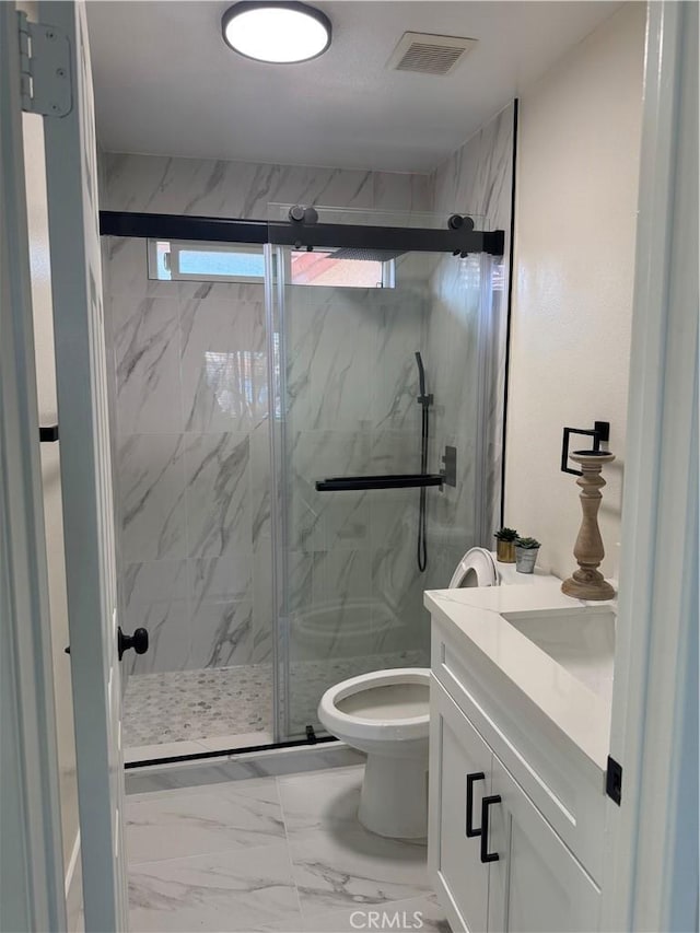 bathroom with a marble finish shower, visible vents, toilet, marble finish floor, and vanity