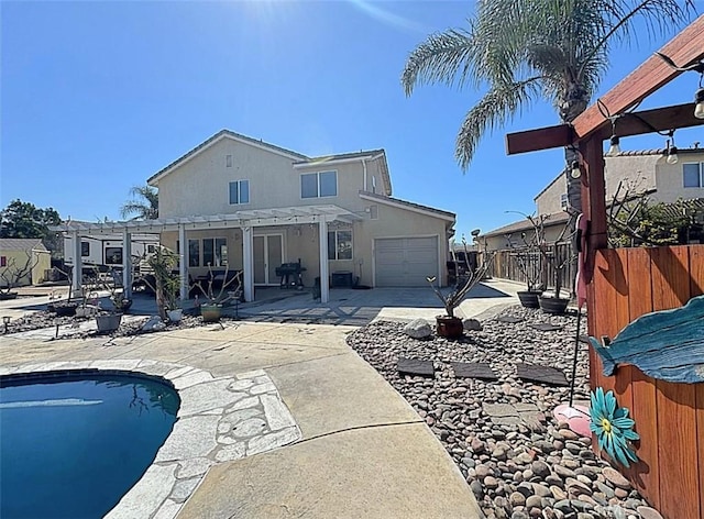 back of property featuring a fenced in pool, fence, an attached garage, a pergola, and a patio