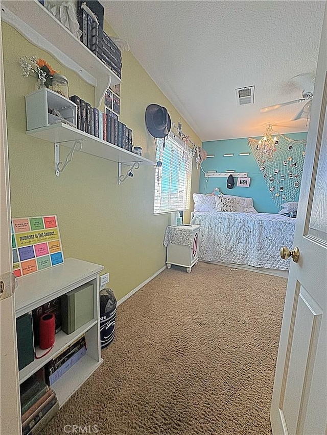 bedroom with visible vents, a textured ceiling, baseboards, and carpet floors