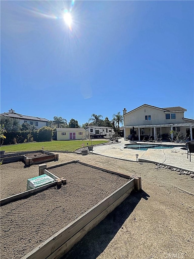 view of yard with a patio and an outdoor pool