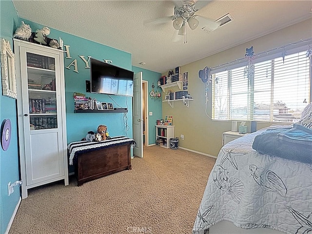 bedroom with visible vents, a ceiling fan, a textured ceiling, carpet floors, and baseboards