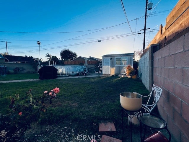 view of yard with an outdoor structure and fence