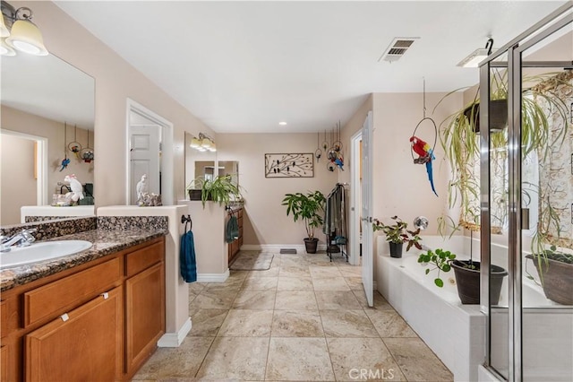 bathroom featuring visible vents, a shower stall, baseboards, a bath, and vanity