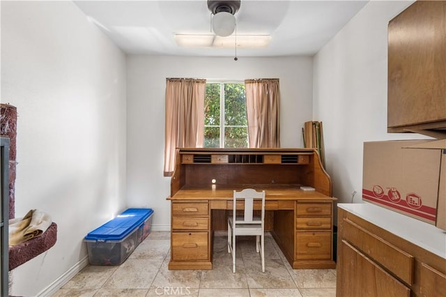 office space featuring light tile patterned floors, baseboards, and ceiling fan