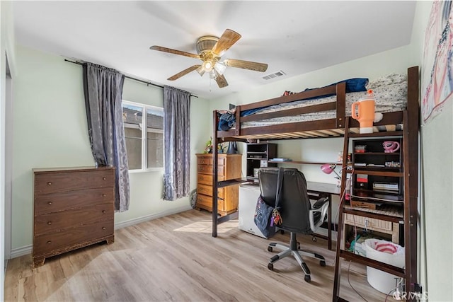 bedroom featuring ceiling fan, wood finished floors, visible vents, and baseboards