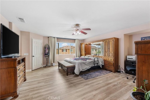 bedroom with baseboards, visible vents, light wood finished floors, and ceiling fan