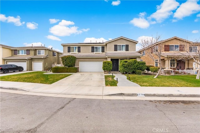 traditional-style house featuring a front yard, an attached garage, driveway, and stucco siding