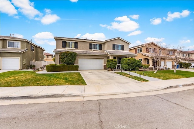 traditional-style home featuring a front lawn, fence, stucco siding, driveway, and an attached garage