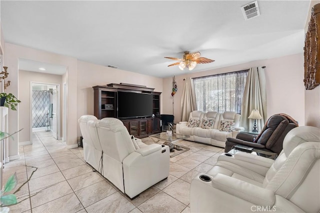 living area with visible vents, light tile patterned flooring, and a ceiling fan