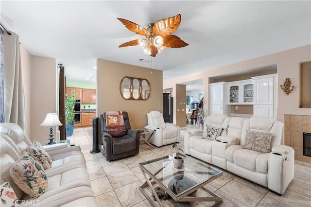 living room with a ceiling fan and visible vents