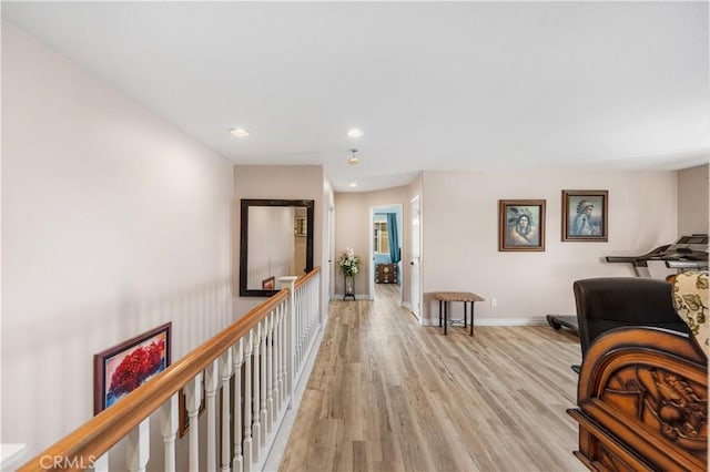 corridor with recessed lighting, baseboards, and light wood-style floors