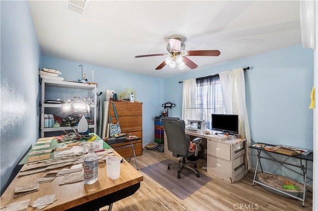 office featuring wood finished floors, visible vents, and ceiling fan