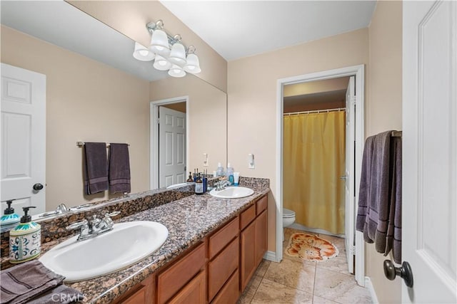 full bath with tile patterned flooring, double vanity, toilet, and a sink