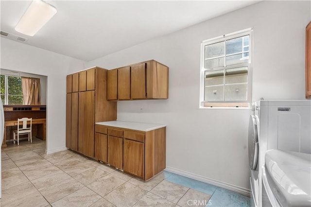 kitchen with a wealth of natural light, visible vents, brown cabinets, and light countertops