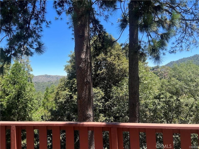 view of mountain feature with a view of trees