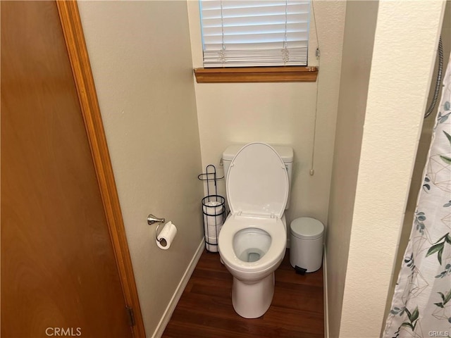 full bathroom with toilet, wood finished floors, and baseboards