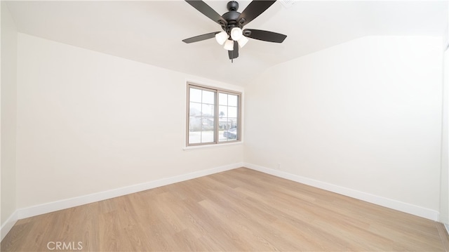 unfurnished room featuring a ceiling fan, light wood-type flooring, baseboards, and vaulted ceiling