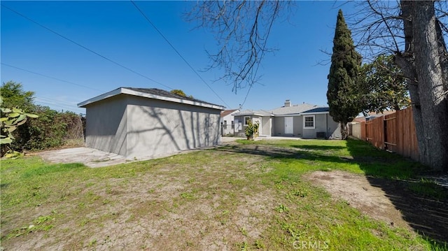 view of yard with an outdoor structure and fence