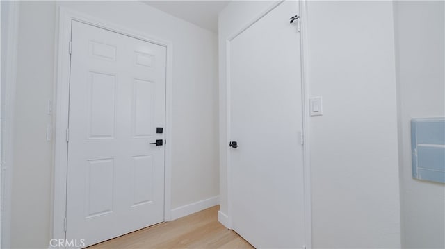 interior space featuring baseboards and light wood-style flooring