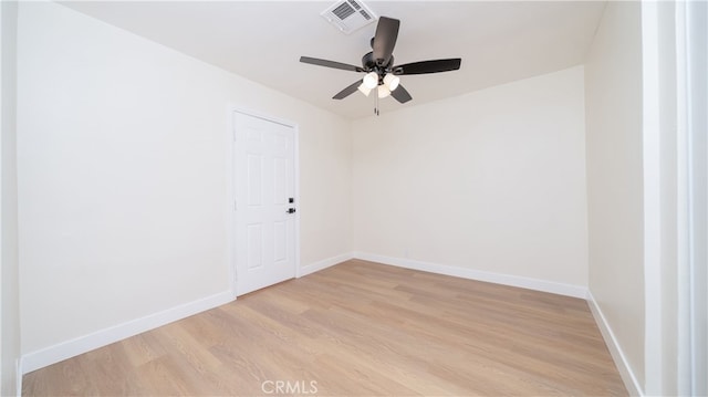 unfurnished room with a ceiling fan, light wood-style flooring, baseboards, and visible vents