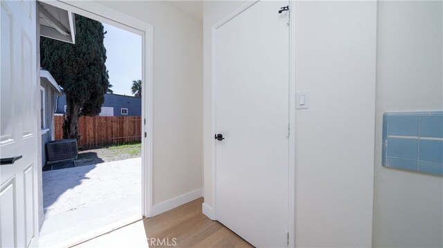 entryway featuring baseboards and light wood-style floors