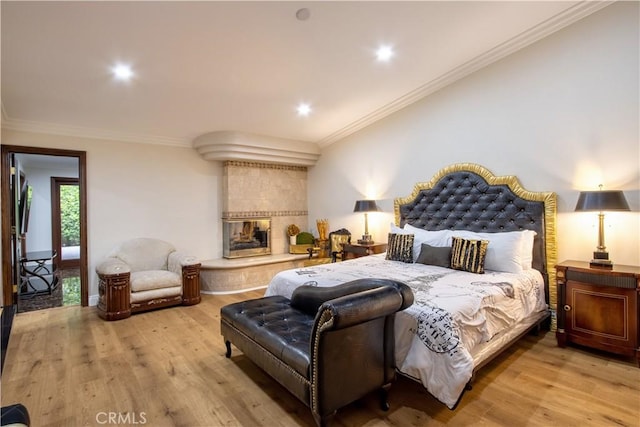 68340 Verano Rd, Cathedral City, CA 92234 - bedroom featuring recessed lighting, a tile fireplace, light wood finished floors, and ornamental molding