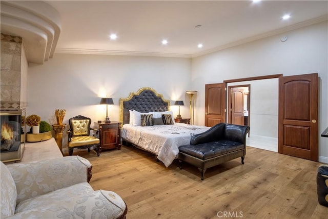 68340 Verano Rd, Cathedral City, CA 92234 - bedroom featuring a tiled fireplace, recessed lighting, crown molding, and light wood-style floors