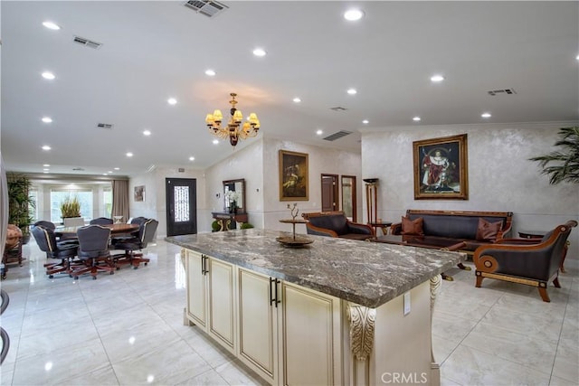 68340 Verano Rd, Cathedral City, CA 92234 - kitchen featuring visible vents, a kitchen island, cream cabinets, and open floor plan
