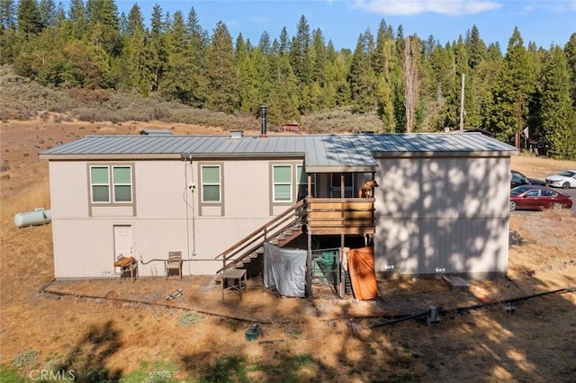 22292 N Tuolumne Rd, Twain Harte, CA 95383 - back of property featuring stairs, a standing seam roof, and metal roof