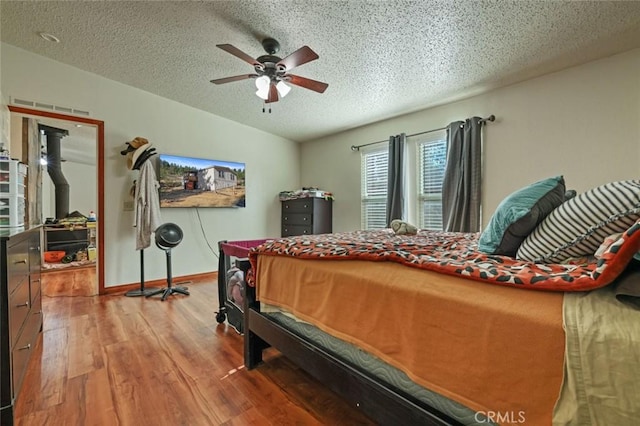 22292 N Tuolumne Rd, Twain Harte, CA 95383 - bedroom with baseboards, vaulted ceiling, wood finished floors, a textured ceiling, and a ceiling fan